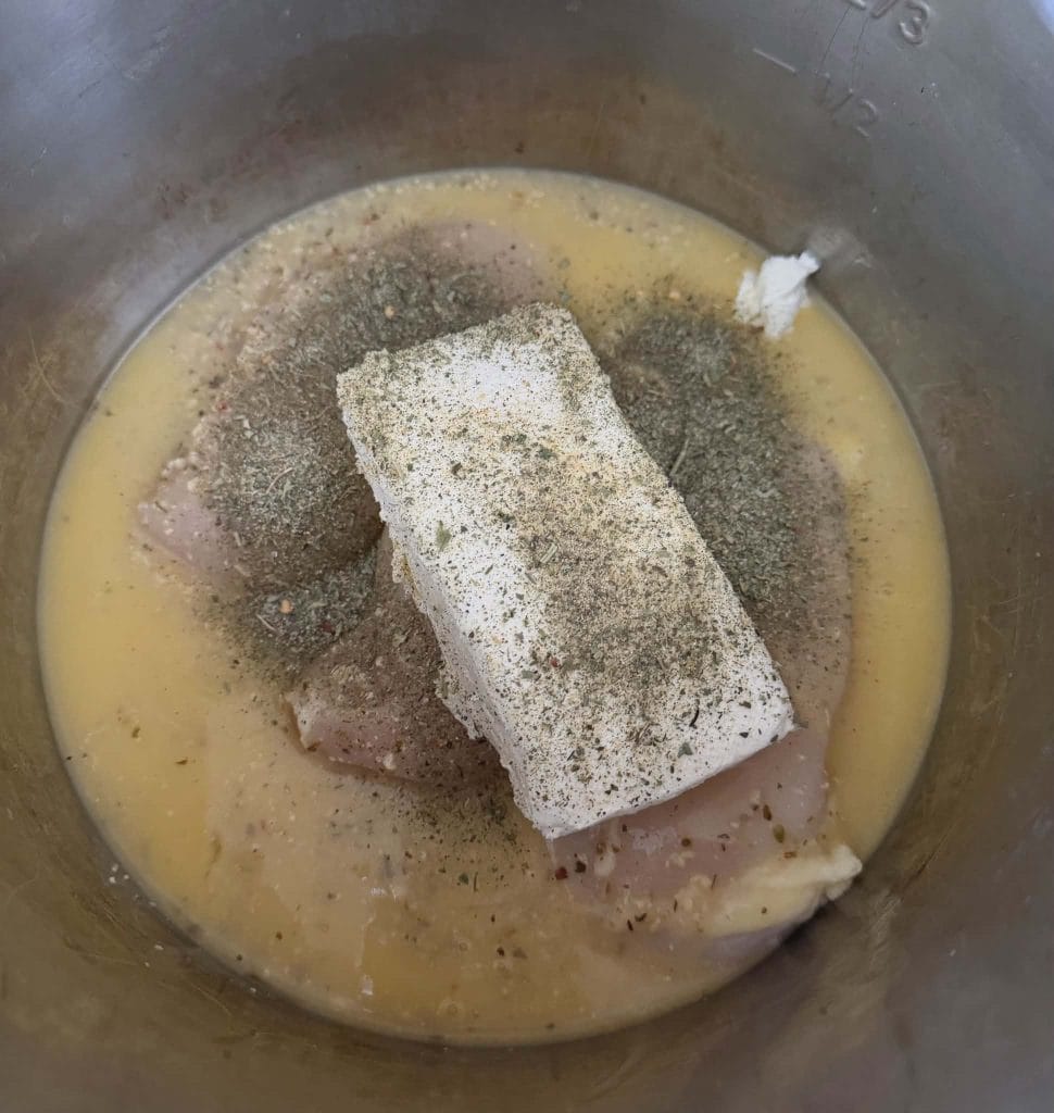Cream cheese and Italian Seasoning on top of chicken for Olive Garden chicken and pasta