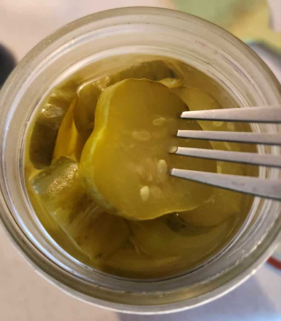 dill pickle in jar with fork