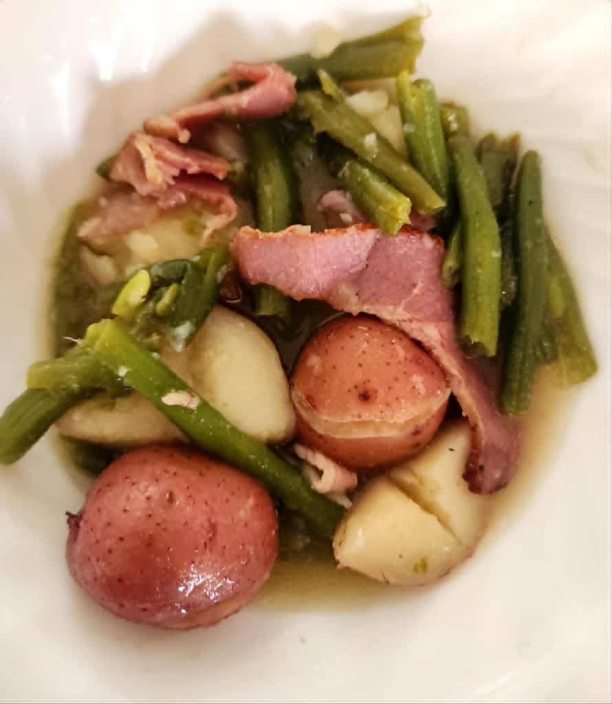 green beans, bacon and potatoes in a bowl