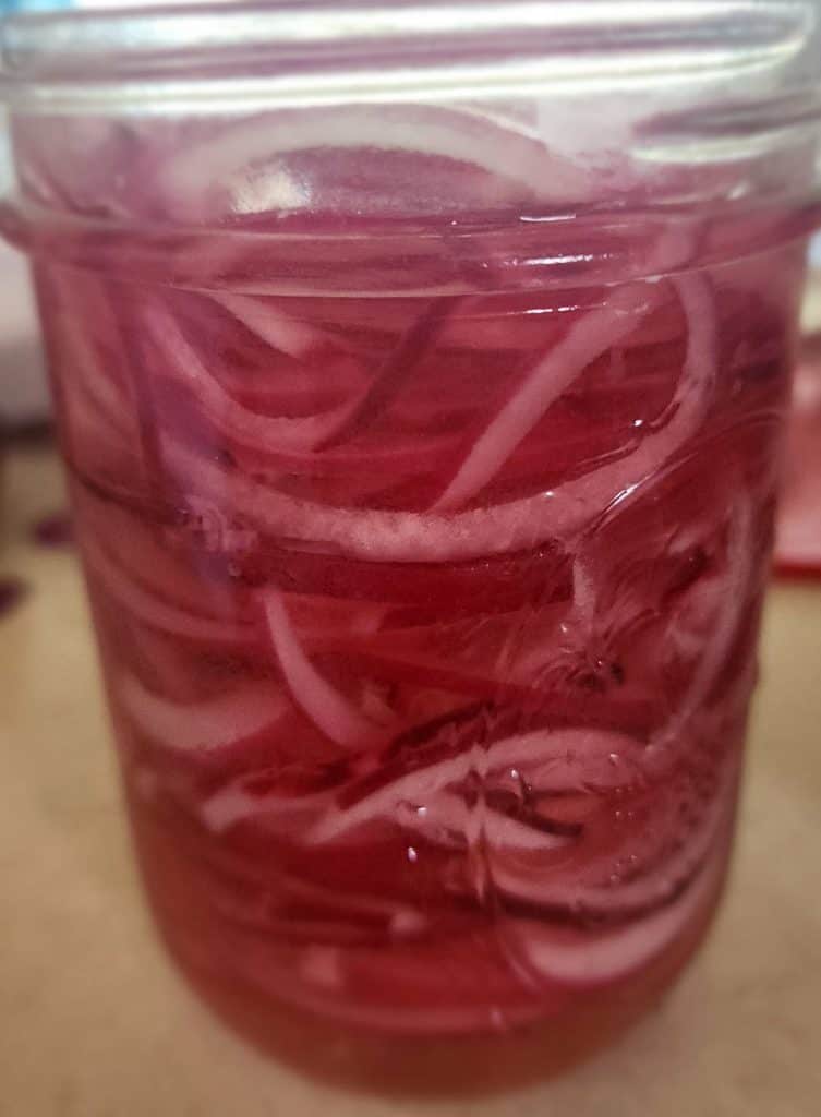 pickled red onions after adding brine