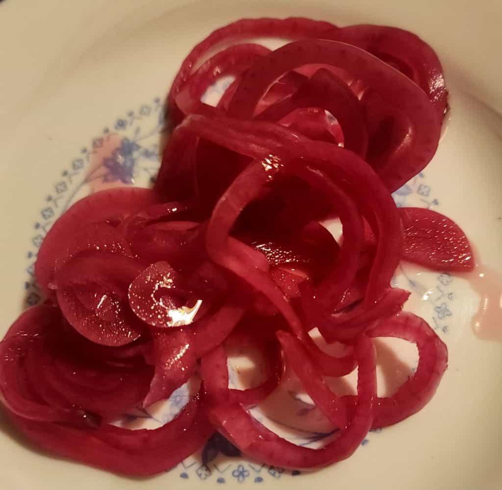 quick red pickled onions on a plate